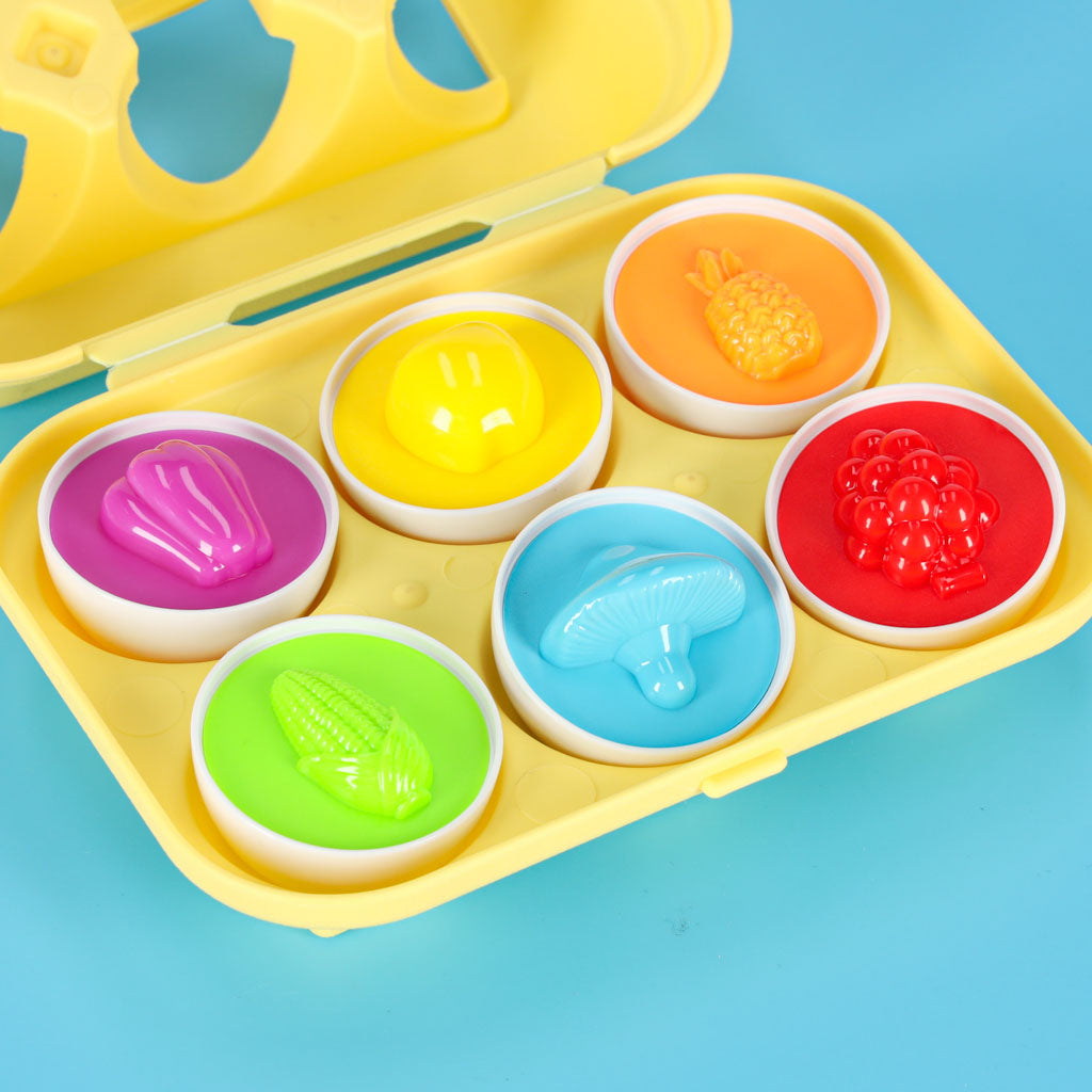 Edukacinis formų rūšiuoklis kiaušiniai „Montessori“ su vaisiais ir daržovėmis, 6 vnt.